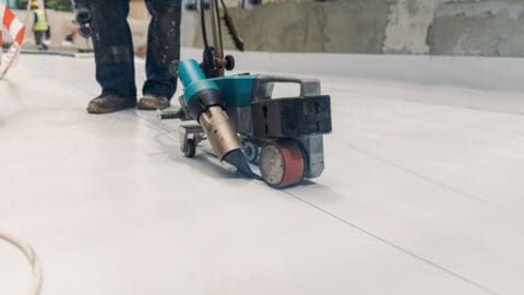 Close up of roofer working on commercial roof