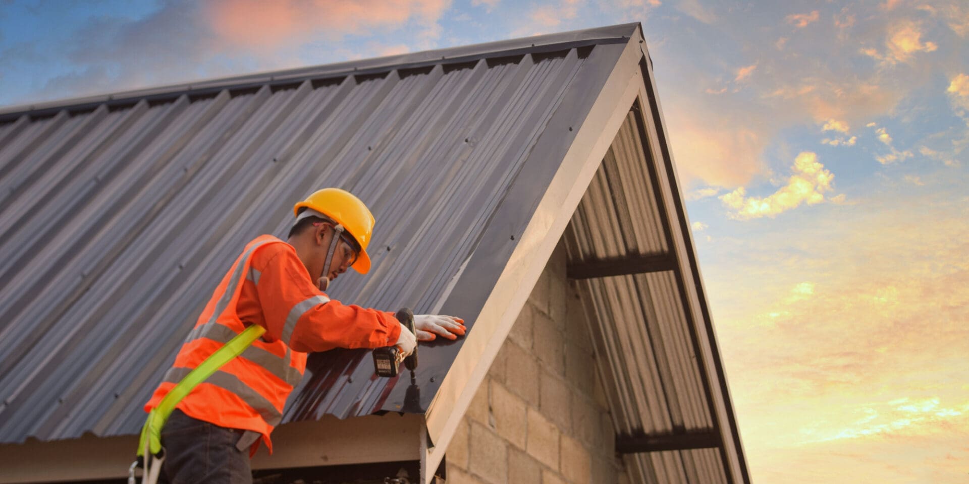 Roofer installing steel roof