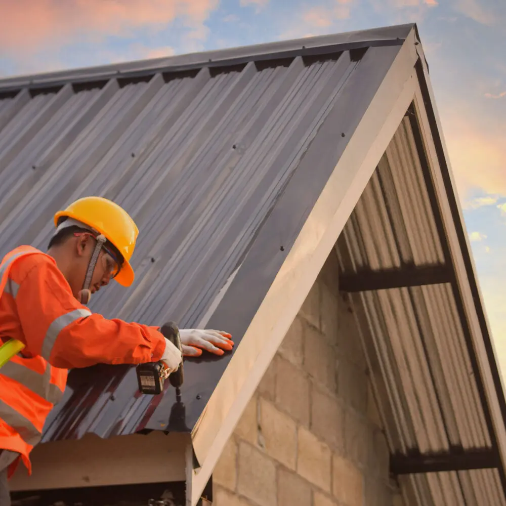 Roofer installing steel roof